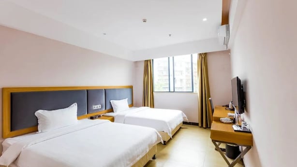 A hotel room with two beds, a desk, a television, and a window with curtains. - Jinlizhou Hotel (Zhuhai)