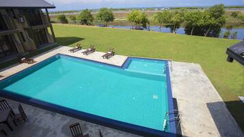 Outdoor pool, open 7 AM to 10 PM, pool umbrellas, pool loungers