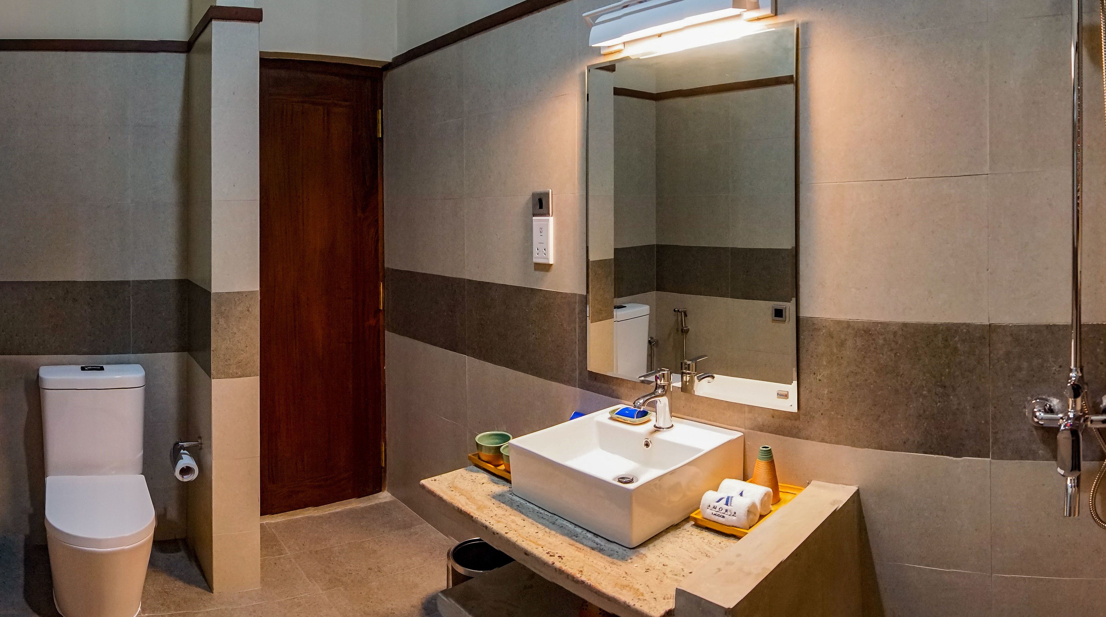 Ein Badezimmer mit Waschbecken, Spiegel und Toilette.