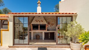 A modern building with a stone facade, large windows, and a chimney. - Casa dos Ninos (Silves)