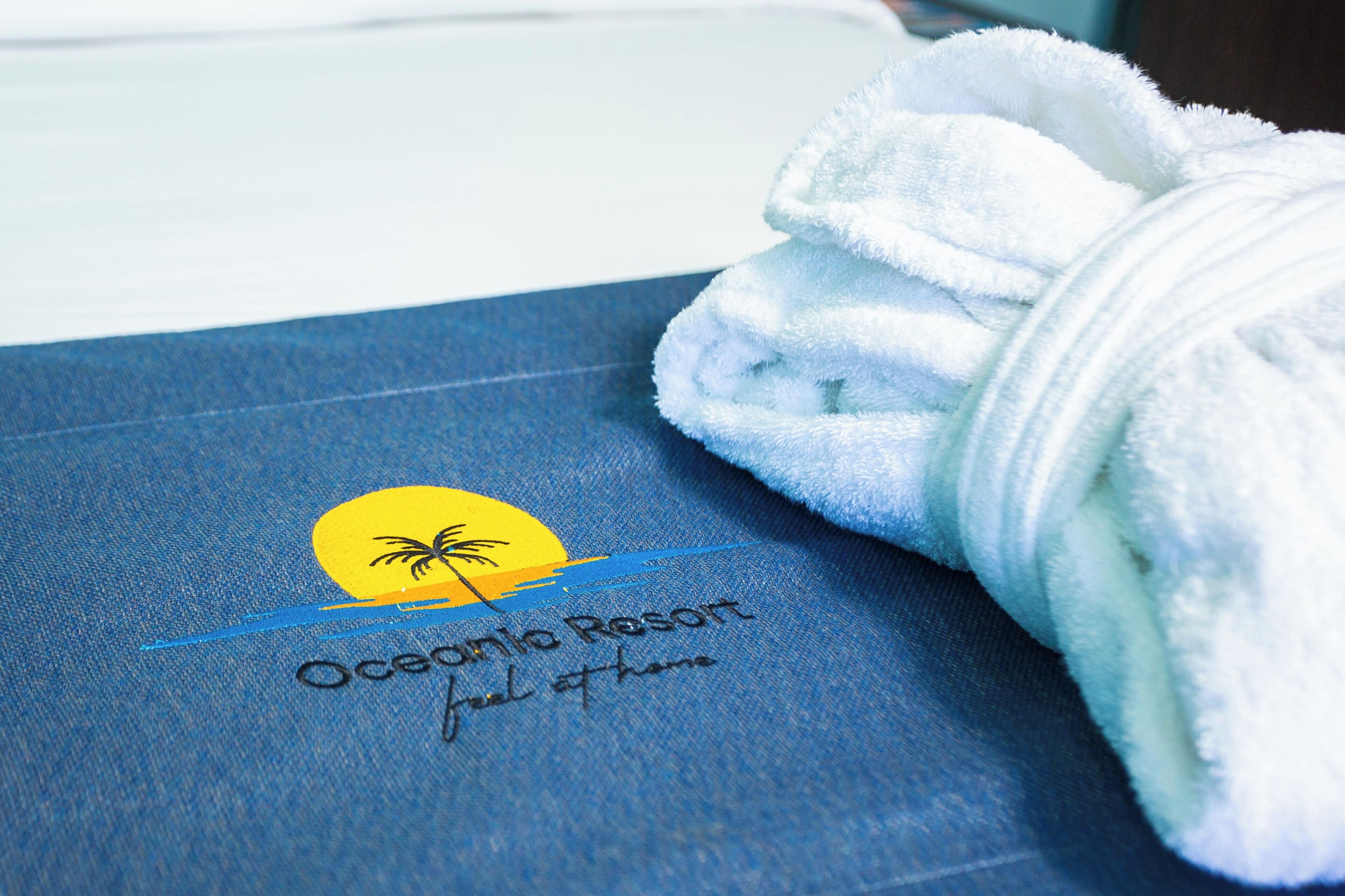 A towel with a logo and text on a blue fabric.