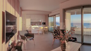 A modern living room with a view of the sea, a dining area, and a kitchen. - Best Seaview Attica Apartment “Sikinos” (Saronida, Athens)