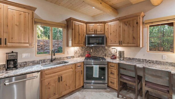 A kitchen with wooden cabinets, a stainless steel stove, and a granite countertop. - Clean and Comfortable, Walk to The Plaza, Ft Marcy (Santa Fe)