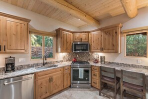 A kitchen with wooden cabinets, a stainless steel stove, and a granite countertop. - Clean and Comfortable, Walk to The Plaza, Ft Marcy (Santa Fe)