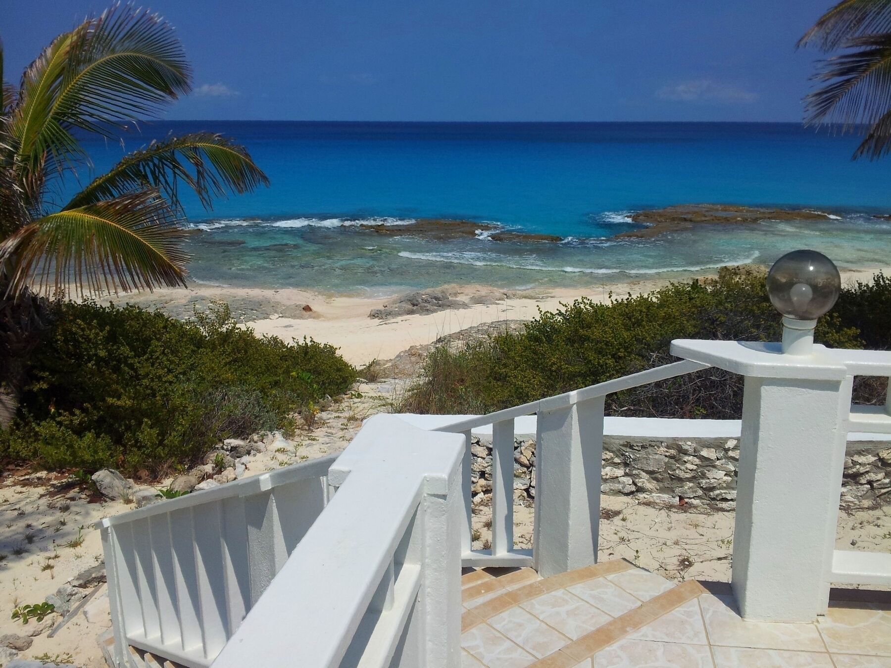 Step access to path to the ocean.  Swim with caution due to ocean rocks and tide