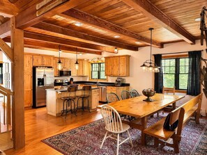 Una cocina amplia con gabinetes de madera, una isla grande y taburetes de bar.