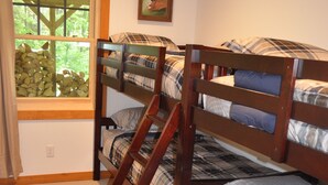 A bunk bed room with a window, a painting on the wall, and a ladder. - Luxurious Mountain Cabin near Okemo with High-End Modern Amenities for up to 12 (Ludlow)