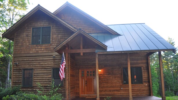 A wooden cabin with a porch and a metal roof. - Luxurious Mountain Cabin near Okemo with High-End Modern Amenities for up to 12 (Ludlow)