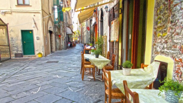 A narrow cobblestone street with outdoor seating at a café, featuring stone walls and traditional European architecture. - Three-room apartment in a strategic location between downtown and the sea CIN IT009002C2KQ9JCI5G (Albenga)