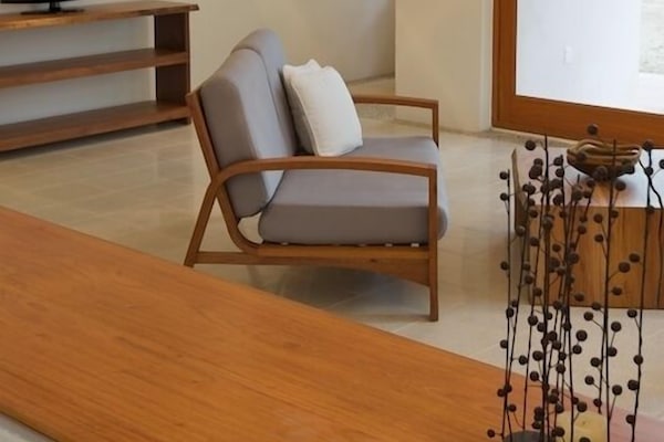 Living area facing the TV with a peek at the patio downstairs facing the ocean