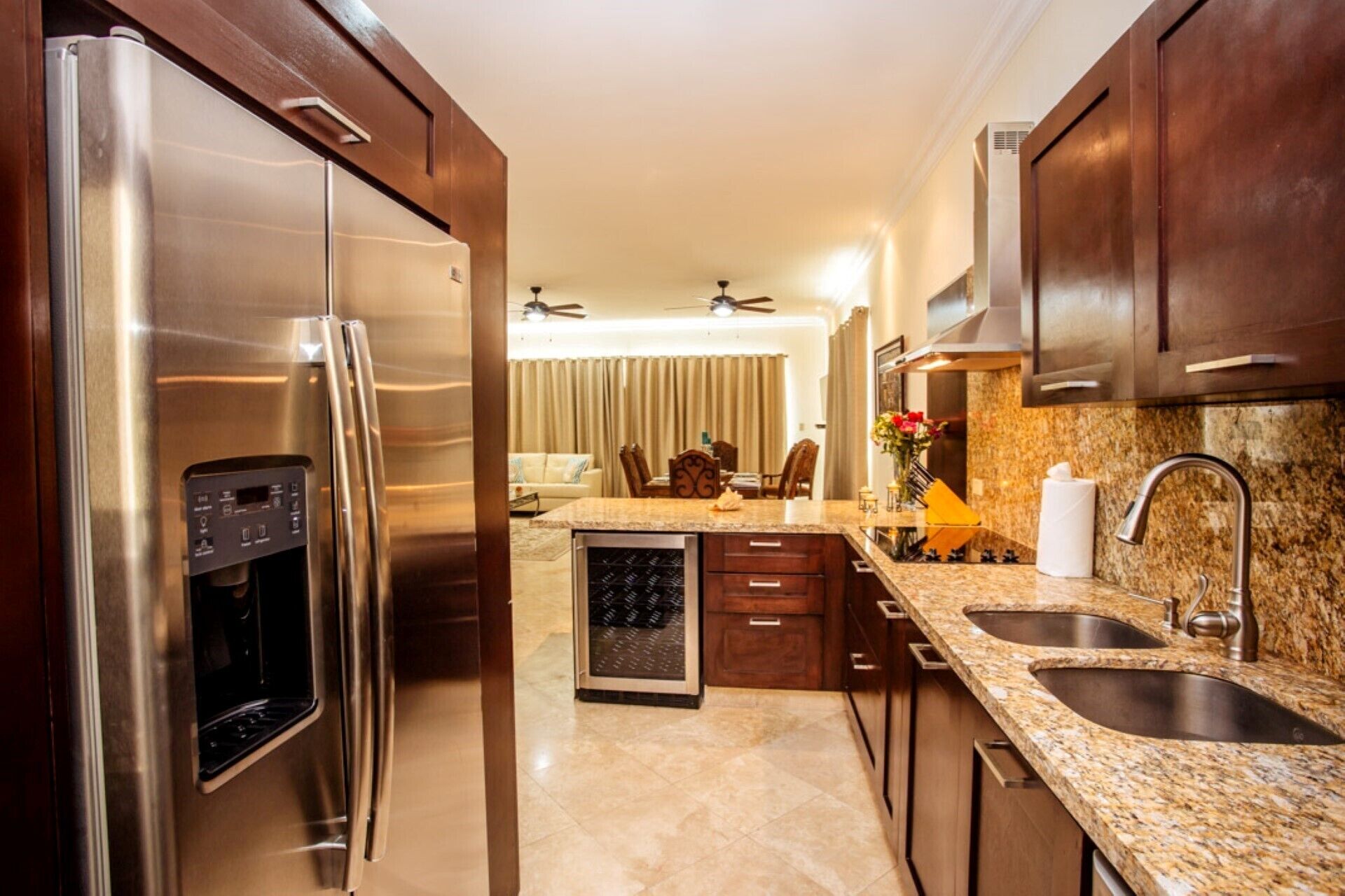 A modern kitchen with stainless steel appliances, granite countertops, and wooden cabinets.