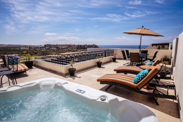 Relax in your jacuzzi on your private rooftop deck viewing the beach.