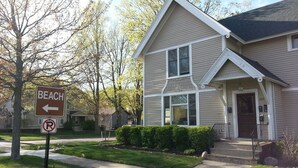 A two-story house with a front porch and a driveway.