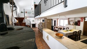 A spacious interior with a dining area, a kitchen, and a staircase leading to an upper level. - CASA-MOLINO: Emerald pool. Ideal for families. Beautiful terrace. Views. (Jimera de Líbar)