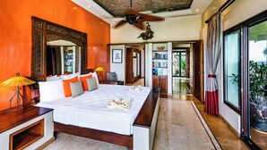 A spacious bedroom with a large bed, a ceiling fan, and a view of the outdoors through a sliding door. - Casa Pipilacha♛Ocean view Infinity Edge Pool with  in-law suite♛ (Tamarindo)