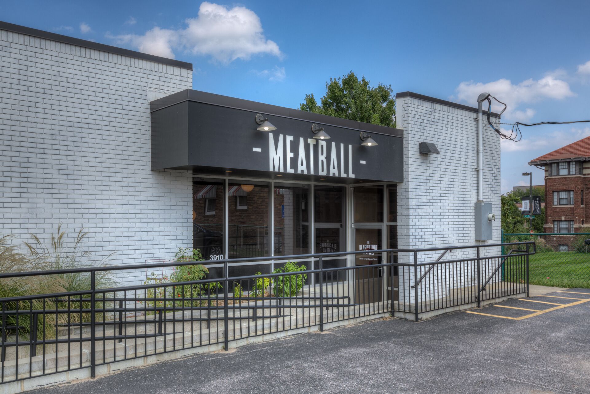 A building with a sign reading "MEATBALL" and a number "3910" on the window.