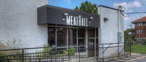 A building with a sign reading "MEATBALL" and a number "3910" on the window.