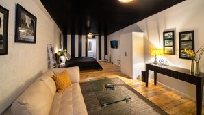 A modern living room with a sofa, coffee table, and artwork on the walls. - Downtown Cozy Condo -Walk to Best Diners, Breweries, NAU, Historic Flagstaff! (Flagstaff)