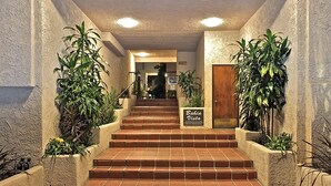 A staircase leading to a door with a sign reading "Bahia Vista Condominium."