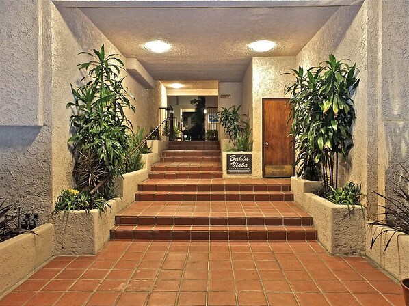 A staircase leading to a door with a sign reading "Bahia Vista Condominium."