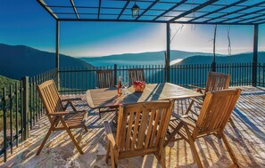 Enjoy a meal or drink on the outdoor dining area with a scenic view of the surrounding hills and water.