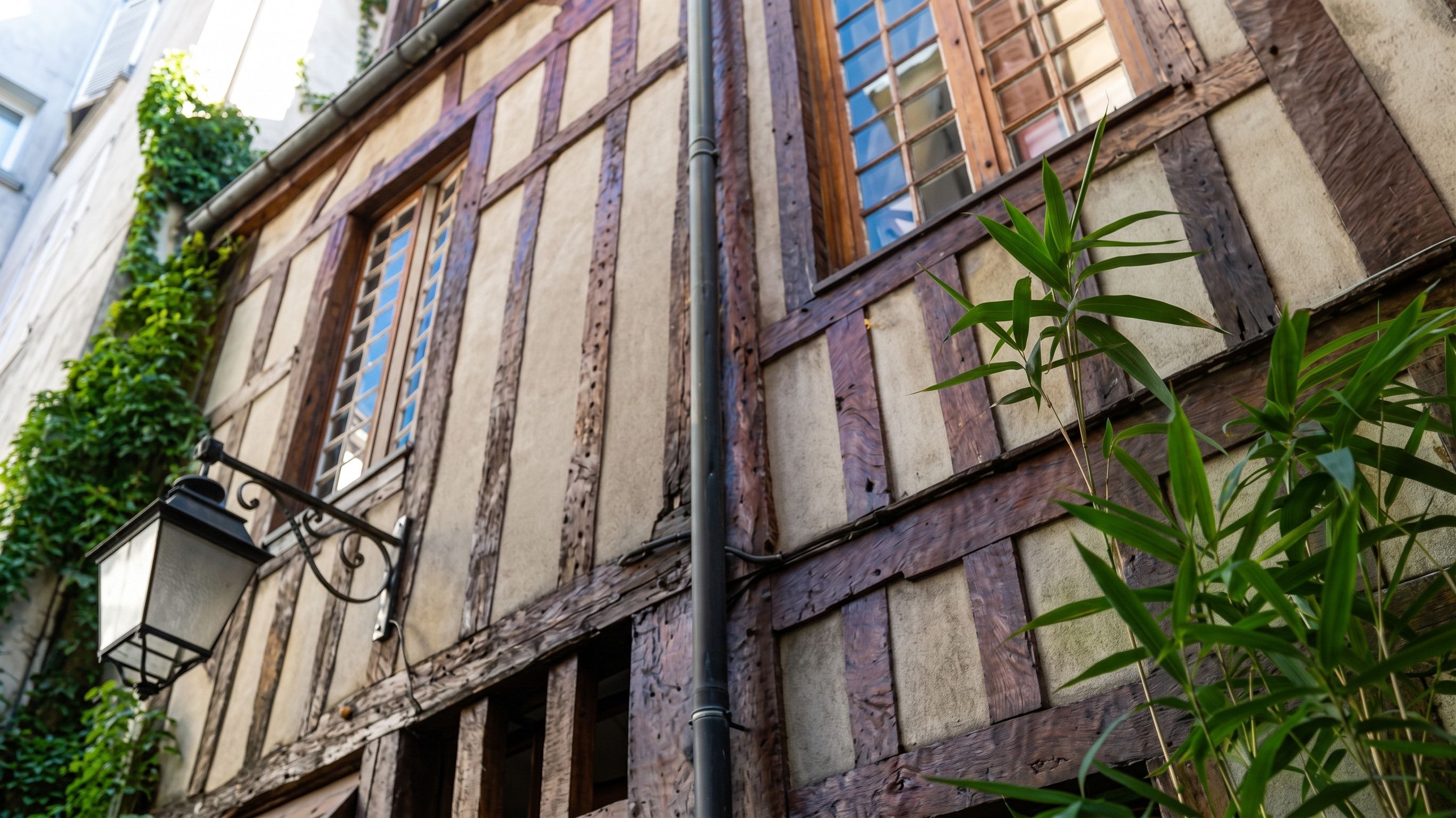 A half-timbered building with exposed wooden beams and a street lamp.