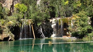 A natural landscape with a clear water body, rocky cliffs, and dense forest. - In the heart of Avon -walk to restaurants & gondola!  Immaculate 2bed/2bath (Avon)