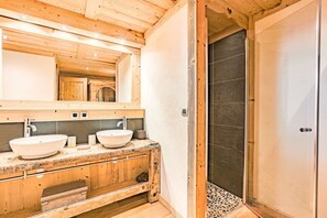 Bathtub, hair dryer, towels, toilet paper