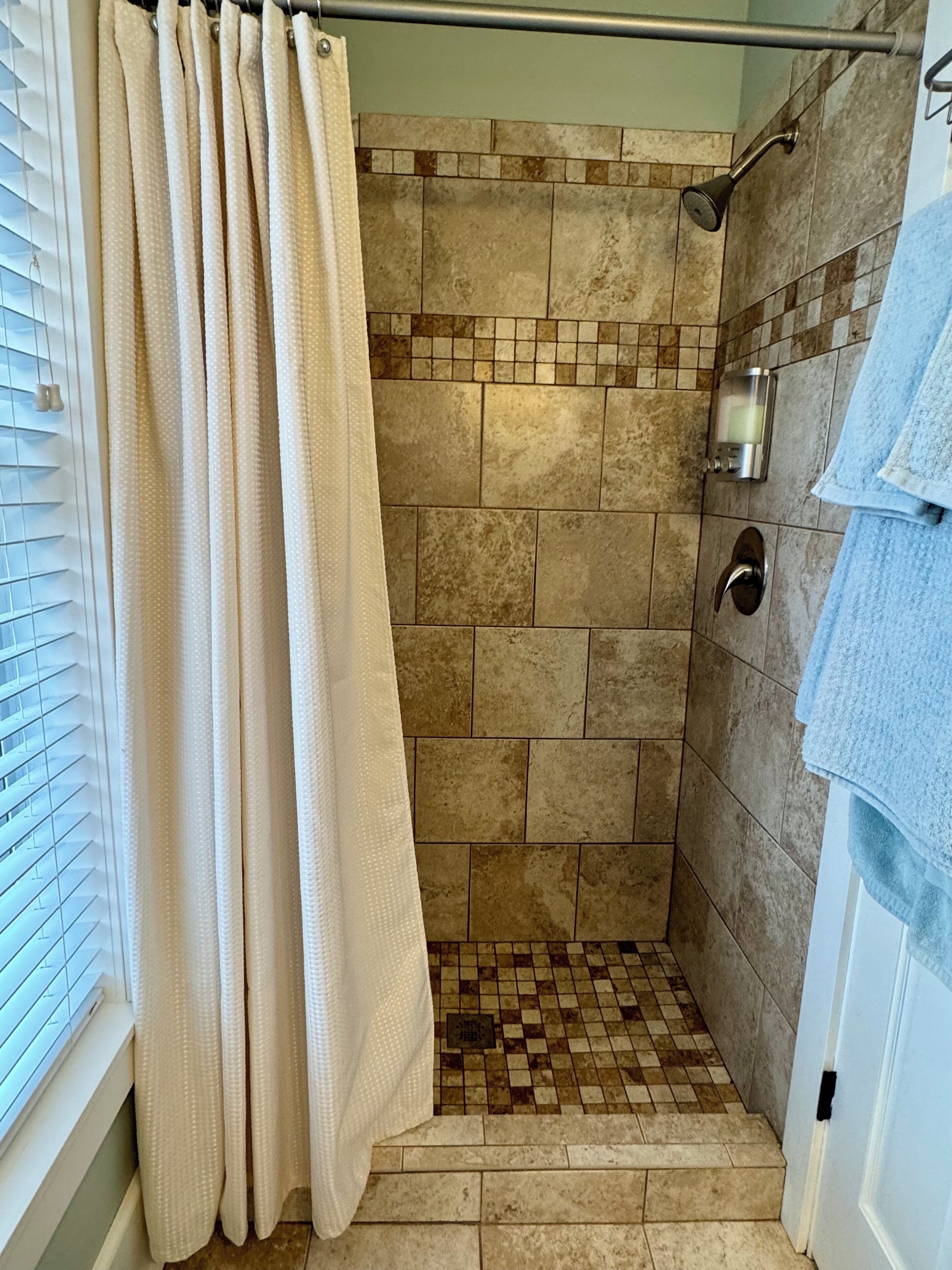 Combined shower/tub, hair dryer, towels, soap
