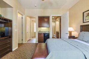A hotel room with a bed, a desk, a television, a kitchenette, and a bathroom. - Near Pool! Best Location! Single Story Poolside Villa across from Clubhouse, Pet Friendly! (C72) (La Quinta)
