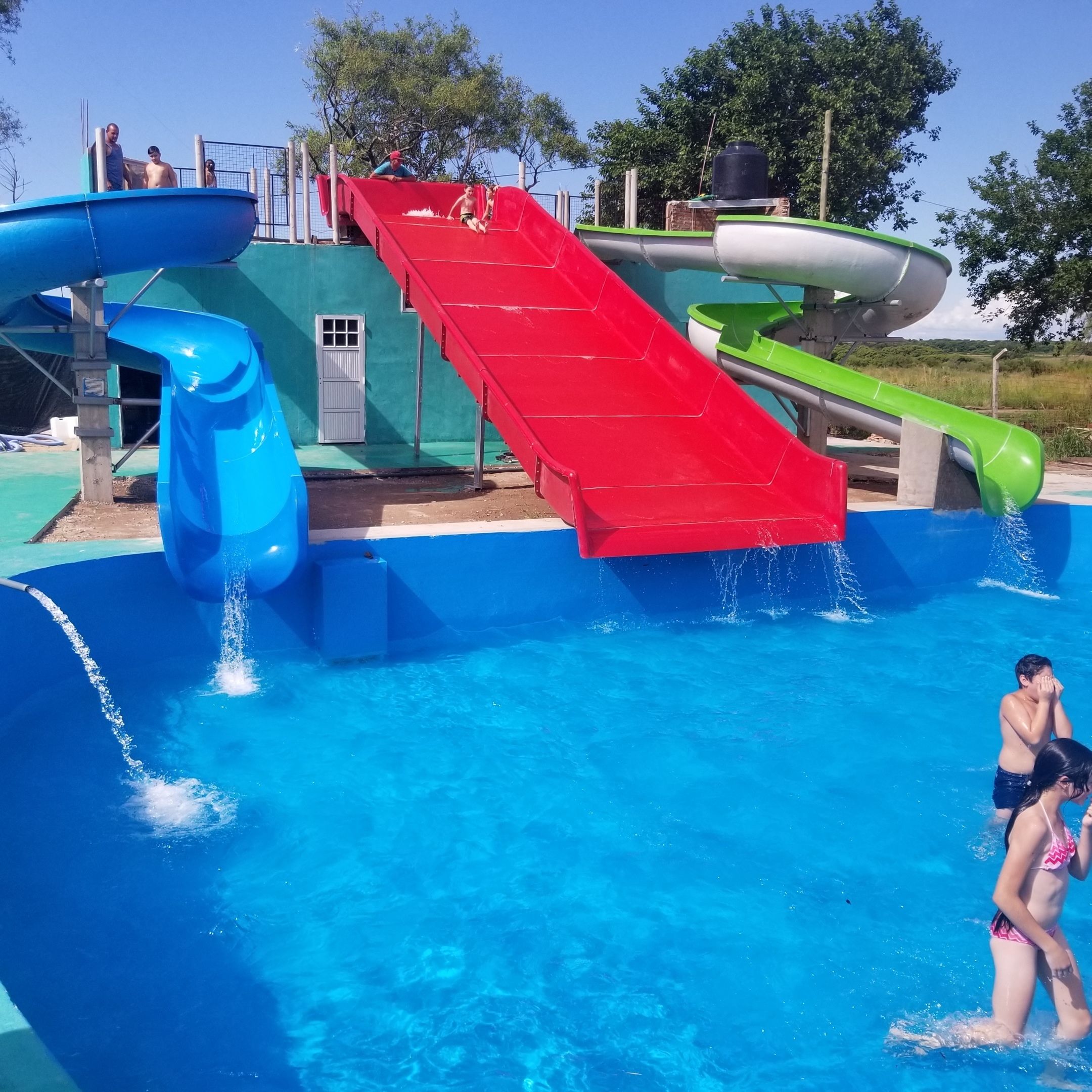 A water park with multiple slides and a pool.