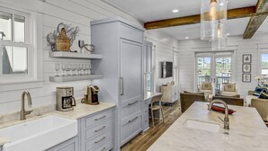 A modern kitchen with a large island, white cabinetry, and a built-in oven. - 'More Grayter' * Lake Views *  Walk To Beach * Gorgeous 5 BR Grayton Beach home * Neighborhood pool (Santa Rosa Beach)