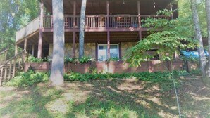 A two-story cabin with a wooden deck and a stone foundation. - Stay at Nina's Cabin in beautiful Blue Ridge, Ga "Gateway to the Smokeys" (Blue Ridge)