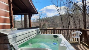 A hot tub on a wooden deck with a view of trees and a clear sky. - Stay at Nina's Cabin in beautiful Blue Ridge, Ga "Gateway to the Smokeys" (Blue Ridge)