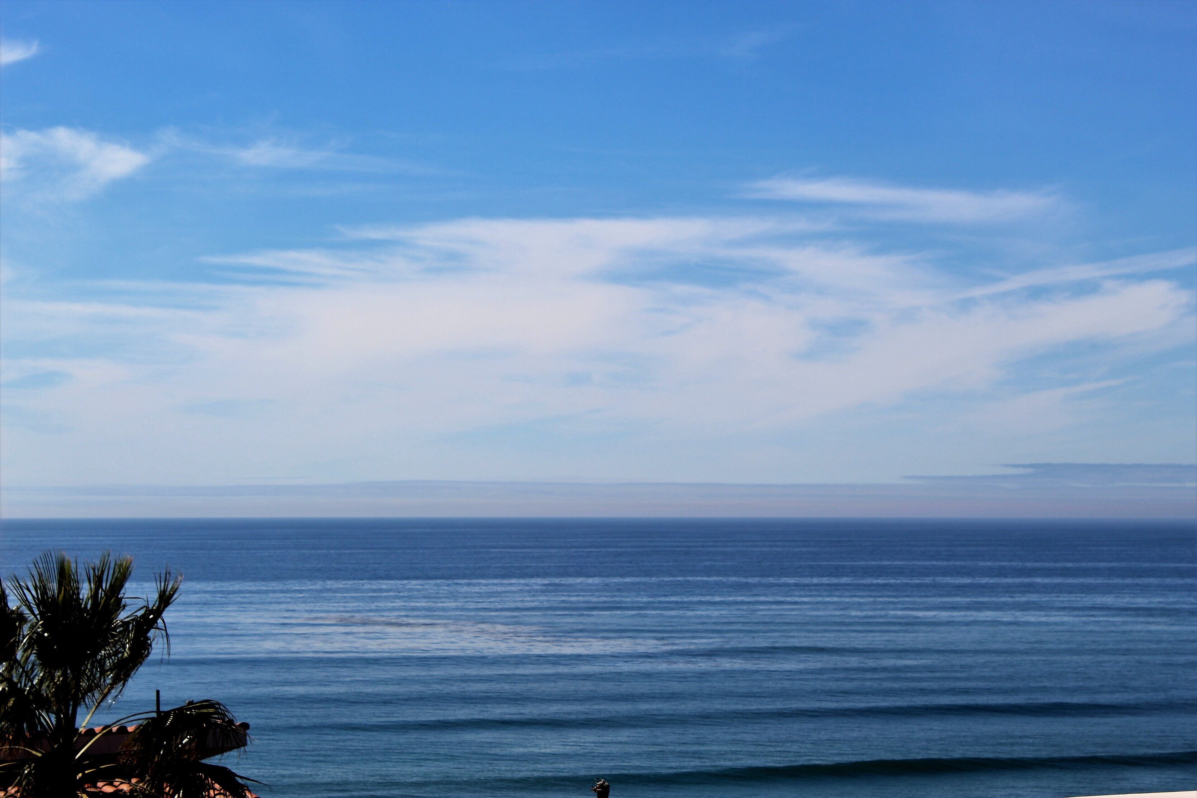 A coastal view with a clear sky and calm sea.