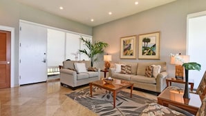 A living room with two sofas, a coffee table, and a plant. - Upgraded 1BD OceanFront Villa w AC Pool - Kapalua Bay Villa 23B1 (Lahaina)