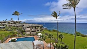 A coastal property with a swimming pool, multiple houses, and a view of the ocean. - Upgraded 1BD OceanFront Villa w AC Pool - Kapalua Bay Villa 23B1 (Lahaina)