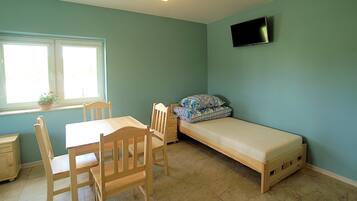 A room with a bed, a desk, and a chair.
