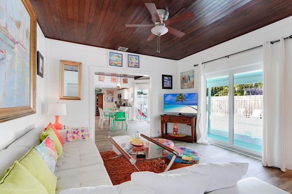 Living room/media room overlooks the pool deck