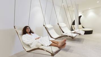 A spa room with hanging chairs and a lounge area.