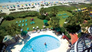 A resort with a swimming pool, sun loungers, and a beach area. - Rare Two-Story Oceanfront Penthouse • 5 Balconies • Stunning Beach Views (Myrtle Beach)
