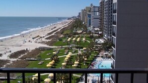A beachfront hotel with a pool, beach access, and a view of the ocean. - Rare Two-Story Oceanfront Penthouse • 5 Balconies • Stunning Beach Views (Myrtle Beach)