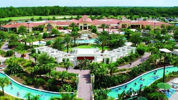 A resort with a central pool, multiple guest buildings, and lush landscaping.