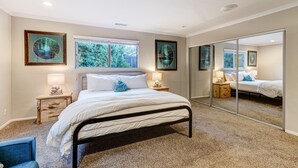 A bedroom with a large bed, two bedside tables with lamps, a mirror, and framed artwork on the walls. - Hidden Gem! Vista 4B, Private, Outdoor Living, Spacious, Work Crews & Families (Vista)