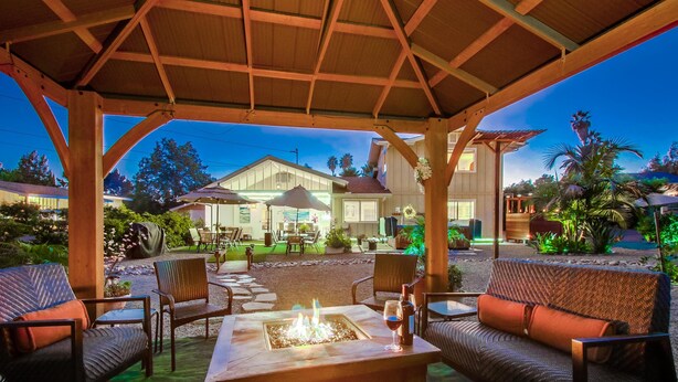 An outdoor patio area with a fire pit, seating, and a covered structure. - Hidden Gem! Vista 4B, Private, Outdoor Living, Spacious, Work Crews & Families (Vista)