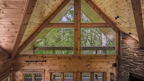 A wooden cabin with a triangular roof, stone wall, and multiple windows. - Blue Ridge Mountain Serenity at The Summit: Hot Tub, Tubing & Hiking Trails (Blue Ridge)