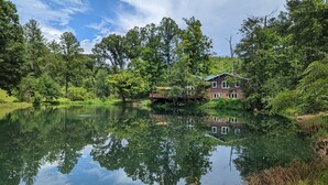 A house by a calm lake surrounded by lush greenery. - Secluded Waterfront Home Located On 82 Private Acres! Close to HH State Park!
 (Laurelville)