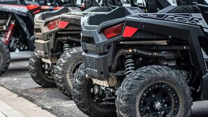 A row of off-road vehicles parked in a line.