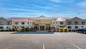 A Comfort Inn & Suites with a central entrance, multiple floors, and a parking lot.