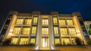 A modern building with a symmetrical facade, large windows, and a central entrance.